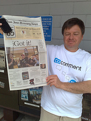 Mark Graham showing off the front page of the Mercury News (local newspaper showing me getting my iPhone)