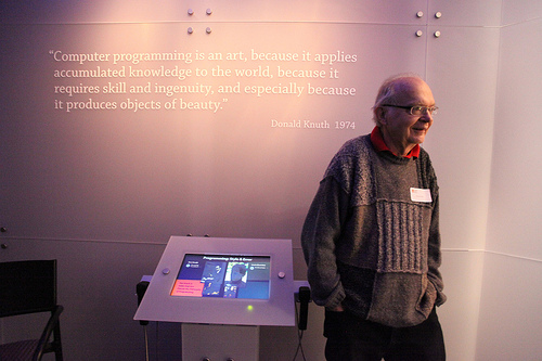 Don Knuth, in front of his quote on the wall
